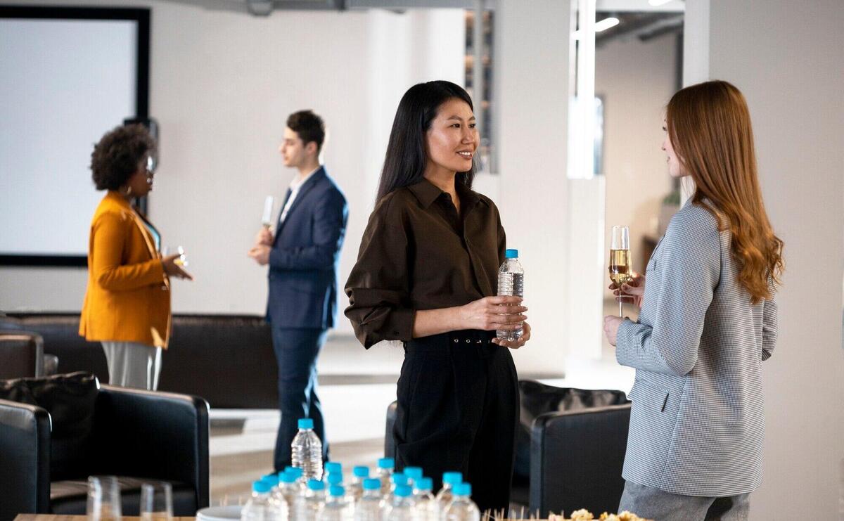 Close up smiley women chatting at company event