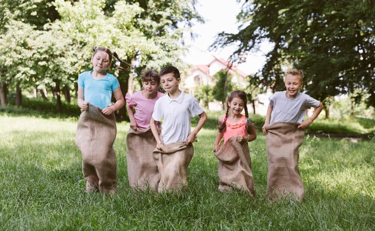 Front view kids competing in burlap bags