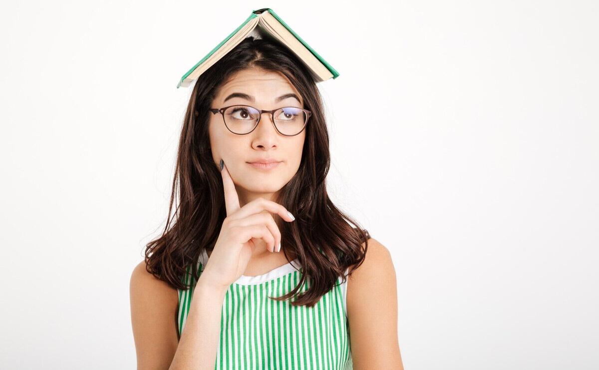 Portrait of a pensive girl in dress and eyeglasses